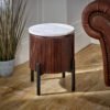 Opal Mango Wood Side Table with a white marble top and vertical ribbed brown body, mounted on black metal legs, set near a brown leather armchair.