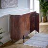 Opal Mango Wood Sideboard with a real white marble top and metal legs in a warm brown mango wood finish, shown with a curved silhouette and paneled doors.
