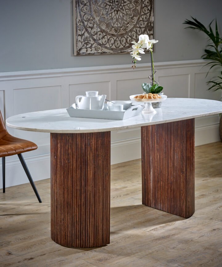 Opal Mango Wood Dining Table 170cm with white marble top, ribbed mango wood legs, placed in a modern dining room with a plant and a brown leather chair.