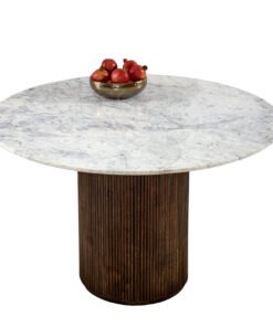 Opal mango wood inspired round dining table with a white marble top and a dark ribbed wooden pedestal base, featuring a small brass bowl of red apples for contrast