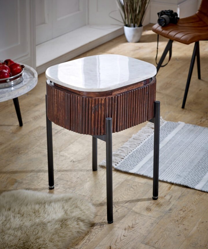 Opal mango wood bedside table with a white marble top and black metal legs, featuring a ribbed wooden body in a stylish interior